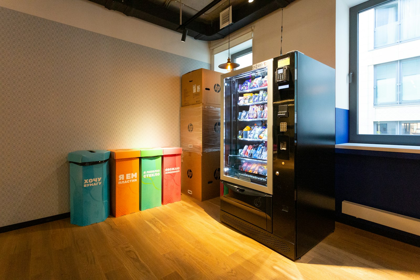 Modern glass-front snack vending machine in an office break area
